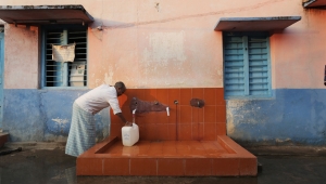 Person filling water jug in india