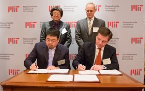 Samuel Tak Lee '62, SM '64 (standing, left) and MIT President L. Rafael Reif look on as Lee's son, Samathur Li, and MIT Executive Vice President and Treasurer Israel Ruiz sign documents related to Lee's $118 million gift to MIT. Image: Bryce Vickmark
