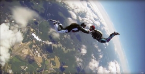 Video screenshot of students sky diving.