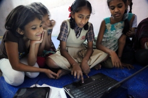 Above: Girls in Mumbai’s Dharavi slum begin building a prototype of their fire-alerting app. Photo courtesy of Nawneet Ranjan.