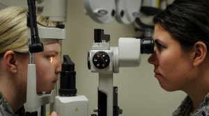 A patient, left, and Capt. Nikki Beadle, an optometrist with the 1st Special Operations Medical Group, perform a slit lamp examination at Hurlburt Field, Fla., Jan. 9, 2017. A slit lamp is used to discover eye problems, such as glaucoma, early on and to provide guidance for future treatment. (U.S. Air Force photo by Airman Dennis Spain)