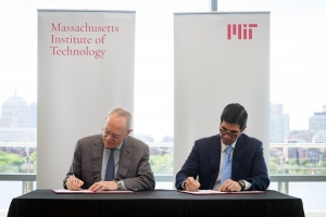 MIT President L. Rafael Reif (left) and Talal Shair sign documents related to the collaboration between the Dar Group and MIT. Photo: John Gillooly
