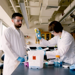 Two students work in an MIT lab