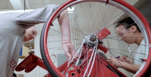 screen shot from education video. Students working on a bike.