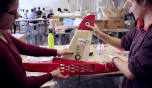 Screenshot from education video. Two women work on a model.