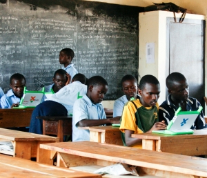 Childrens learn together on laptops in Kagugu Africa classroom. Image: One Laptop Per Child