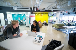 Students work together at a table in the Martin Trust Center. Image: MIT Sloan