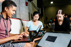 Three students work on laptops at the HackMIT hackathon in the Johnson Ice Rink at MIT in Cambridge, Massachusetts, USA. Image: M. Scott Brauer