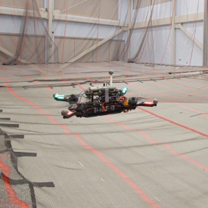Image of a drone flying inside an indoor lab at MIT.