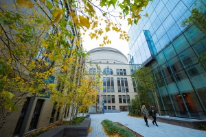 Two students walk through MIT's campus
