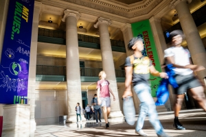People walk through Lobby 7 on MIT's campus