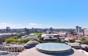 An aerial view over the MIT Great Dome with a view of the sports fields.