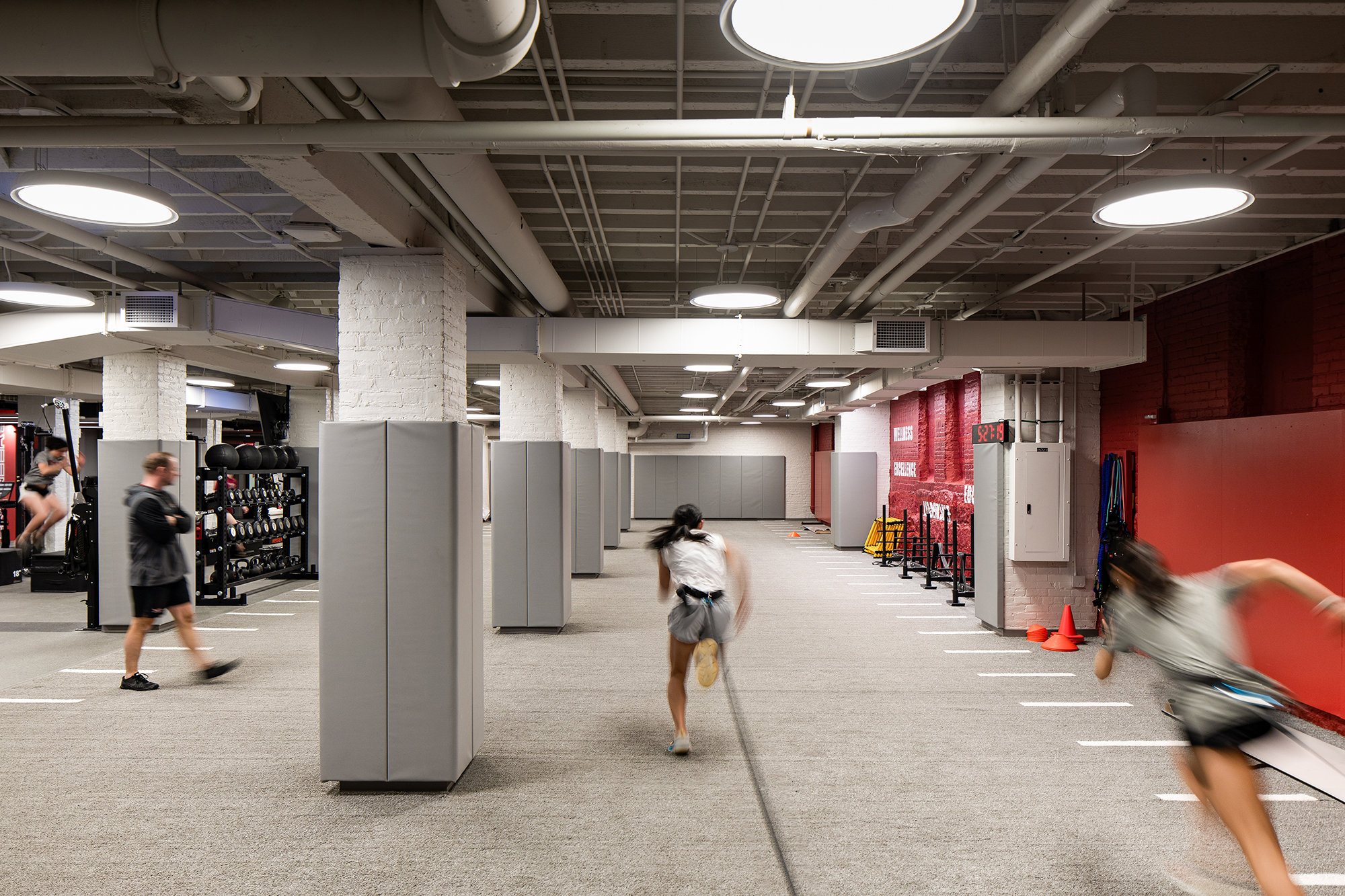 Athlete sprinting inside MIT's Sports Performance Center